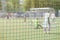 Football, soccer field, soccer gate, view from soccer goal net, blurred stadium, field pitch. Football training