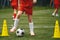 Football soccer kids team exercising with balls. Young athletes during the team training before the match. Young players