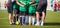 Football soccer match for children. Coach giving young soccer team instructions. Youth soccer team together before final game