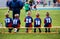 Football soccer match for children. Kids waiting on a bench. Soccer school tournament match. Football school tournament for kids