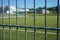 Football or soccer pitch seen through fence