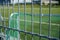 Football or soccer pitch seen through fence