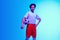 Football or soccer player on gradient background in neon light - motion, action, activity concept