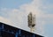 Football stadium light structure on stand roof in sunny day