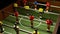 football on the table at night the light blinks goal, toy red white, EUR face. Competitive taca figurine table soccer