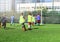 Football team - boys in red and blue, green uniform play soccer on the green field. Team game, training, active lifestyle,