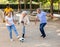 The football team of positive elderly diverse people having football activity on a sandy area in autumn afternoons in