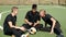 Football team resting on soccer field