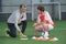 Football trainer and player during practice