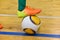 Footballer foot knocks the ball after an strike from the sideline in a mini-football in the hall