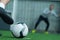 Footballer kicking ball into gate on field