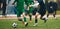 Footballers in action on the tournament game. Soccer football players competing for ball and kick ball during match in the stadium