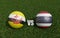 Footballs in flags colors on soccer field. Brunei Darussalam with Thailand. 3d