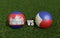 Footballs in flags colors on soccer field. Cambodia with Philippines. 3d