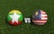 Footballs in flags colors on soccer field. Myanmar with Malaysia. 3d