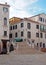 A footbridge crossing a canal in salizada dei greci in the castello area of houses and buildings in venice