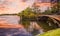 Footbridge over the pond in the city park at sunset. Styled stock photo with wooden bridge in twilight atmosphere in Herastrau