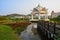 Footbridge and pavilion over lake in sunny afternoon