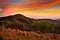 Foothills of Monteverde Cloud Forest Reserve, Costa Rica. Tropic mountains after sunset. Hills with beautiful orange sky with