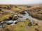 Footpath across Red-a-ven Brook as it cascades over rocks below mist and low cloud, Dartmoor National Park, Devon