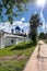 The footpath along the walls of the Holy Bogolyubovo Monastery in sunny summer day, Vladimir region, Russia.