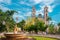 Footpath amidst garden and fountain with San Servacio church