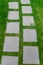Footpath in the grass. Concrete squares laid out in a row