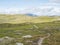 Footpath in northern artic landscape, tundra in Swedish Lapland with green hills and mountains at Padjelantaleden hiking