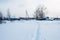 Footpath in snow in traditional russian village