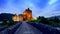 Footpath to the beautiful illuminated Eilean Donan Castle at sunset, Scotland