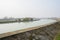 Footpaths along countryside irrigation canal in sunny winter