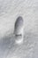 Footprint of a man in a boot in the snow
