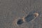 Footprint on marine sand from shoes large size, footprint male its feet, the bottom place for text free, texture