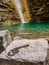 Footprint on the stone behind the waterfall