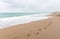 Footprints along a deserted sandy beach