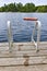 Footprints on dock at summer lake