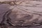 Footprints on drying road dirt after heavy rain. Bicycle and shoe prints. Summer evening