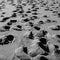 Footprints on grey beach sand