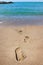 Footprints leading into the ocean