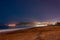 Footprints leading to the little foggy Tono`s Bay or Baia del Tono. Silk effect and some stars in the background. Sicily, Italy