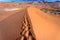 Footprints in the ridge of sand dunes in Moroccan Sahara desert