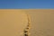 Footprints on the sand on a dune in the Sahara desert