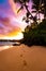 Footprints in the sand on paradise beach at sunset Maui Hawaii