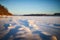 Footprints of in the snow field in cold winter morning or evening during sunrise or sunset