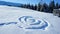 footprints in the snow in the form of a spiral pattern on a snowy slope of a mountain meadow with clear snow