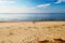 Footprints on a sunny, empty beach.