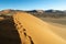 Footprints in undulating ridge lines of dunes of Hidden Vlei, So