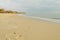 Footprints on a wide sandy beach