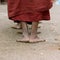 Foots of ascetic Buddhist monk walking