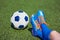 Foots boy soccer in football boots with ball on grass